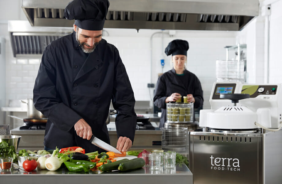 Cook preparing canned food at restaurant with a TERRA Food-Tech autoclave